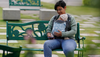 A mother with Baby Carry Bag Sit on Bench